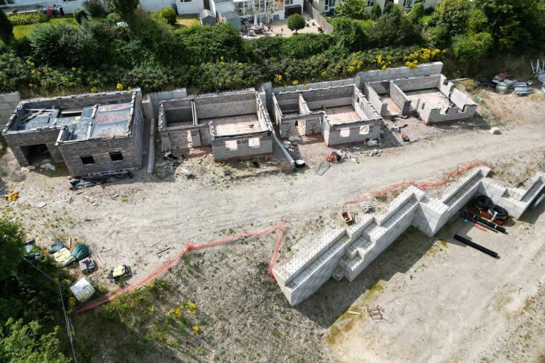 An aerial view of the Locks Hill development site - the photo includes 4 unfinished houses, which now stand half built on the site.