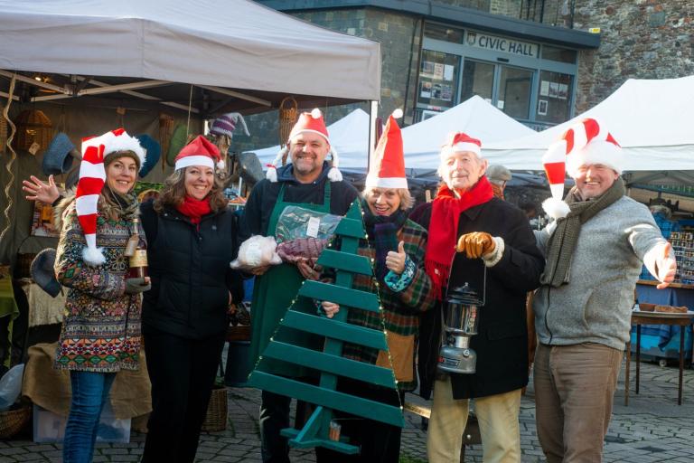 a group of people wearing santa hats 