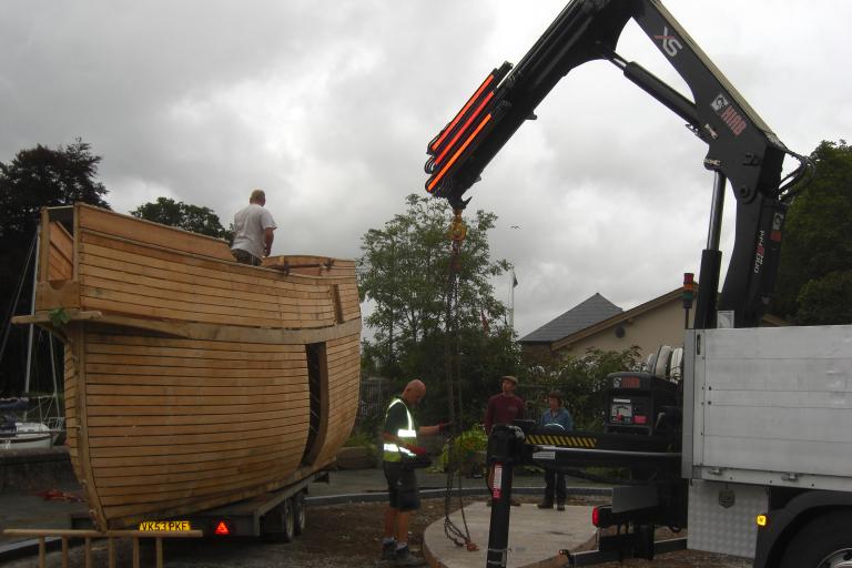 wooden boat with crane