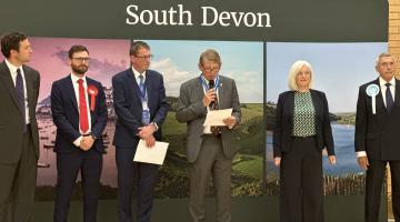 A photo of the candidates of the South Devon constituency learning the result of the 2024 General election poll in the constituency.