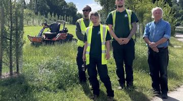 Cllr John McKay and the South Hams Council grounds maintenance team out on a lawn with the new raccoon mower.