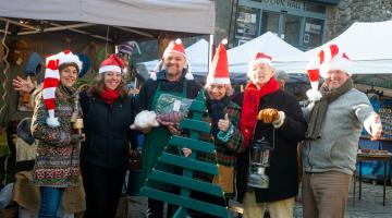 a group of people wearing santa hats 