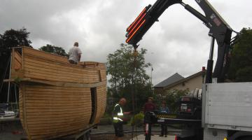 wooden boat with crane